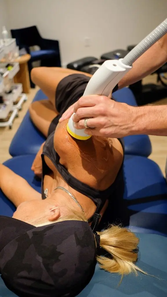 Patient receiving SoftWave acoustic wave therapy at White Meadow Chiropractic in Rockaway, NJ